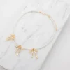 Halsband med pärlor och rosetter - guld
